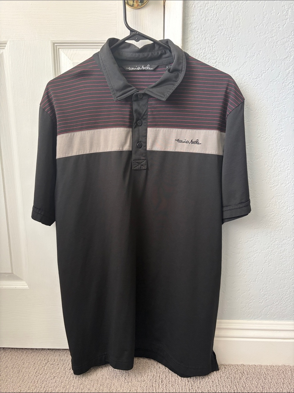 Travis Mathew Black Polo with Gray Chest Band and Red Stripe Accents